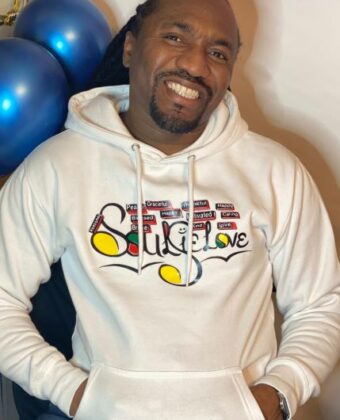 A man wearing a SoulieLove Collections hoodie